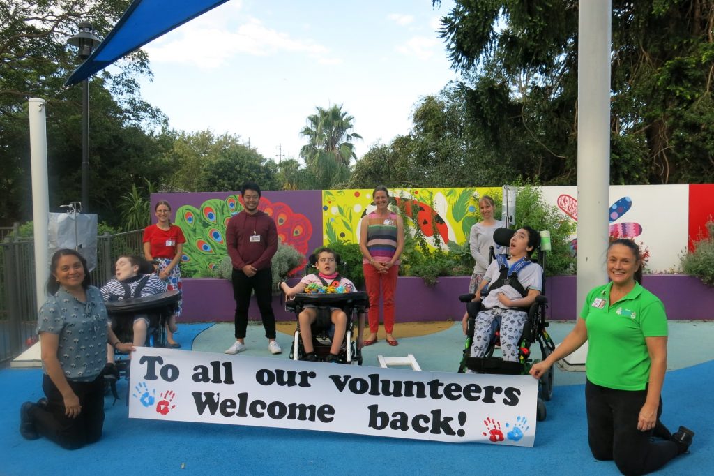 Volunteers, staff and kids celebrating the return to Allowah