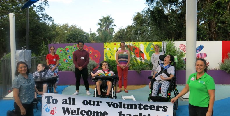 Volunteers, staff and kids celebrating the return to Allowah