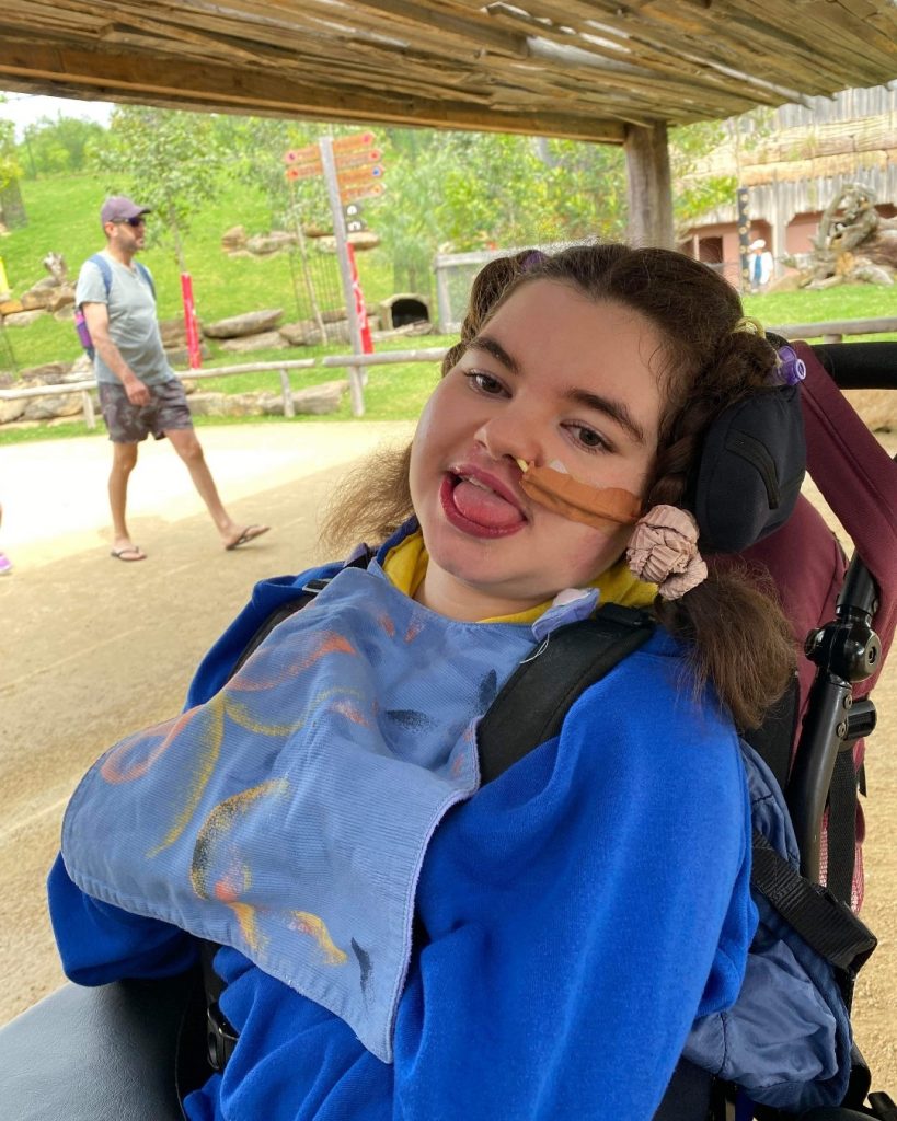Photo of girl in wheelchair attending a zoo excursion